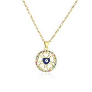 Close-up of 18K gold evil eye pendant with colorful zirconia stones and heart cutouts