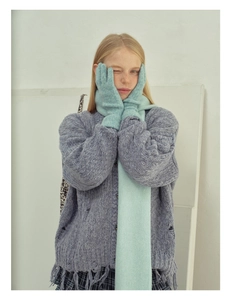 Detailed knit texture of wool blend touchscreen gloves and matching mint green scarf