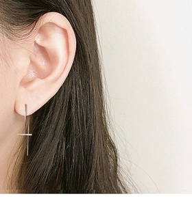 Close-up of elegant S925 silver tassel drop earrings on model for a minimalist chic style