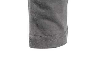 Detail of the double-stitched hem and fine texture on a men's dark grey cotton t-shirt