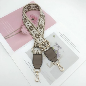 Close-up of adjustable ethnic jacquard bag strap with coffee geometric snowflake patterns