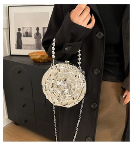 Silver rose clutch with pearl handle and metal chain strap for party evening look