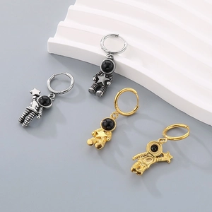 Creative astronaut hoop earrings in gold and silver finish with star relief detail