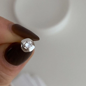 Macro detail of 925 sterling silver stud earring featuring a brilliant round zircon stone