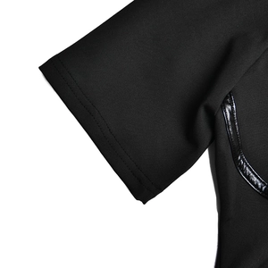 Close-up of black short sleeve cuff with leather patchwork and elastic textured fabric