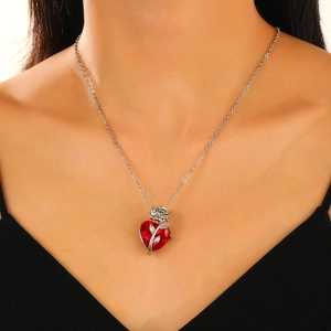 Detail of gothic rose wrapped red heart crystal necklace worn by a model
