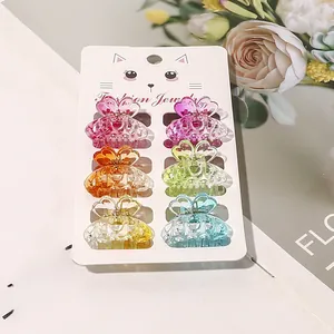 Set of six colorful butterfly mini hair claws in transparent candy colors on a card