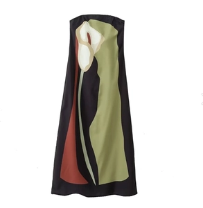 Detail of artistic calla lily floral print on black strapless maxi dress fabric texture