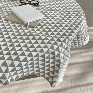 Detail of grey and white triangle geometric cotton linen tablecloth with elegant drape