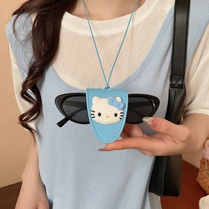 Close-up of light blue leather cat-shaped eyeglass holder with a cute cartoon face