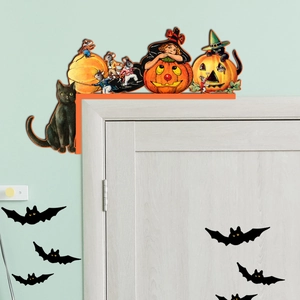 Detail of vintage Halloween door corner decor featuring cat, pumpkin, and bat stickers