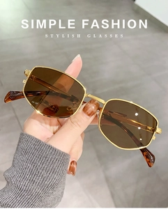 Detailed view of vintage rectangular sunglasses with gold metal frame and brown lenses
