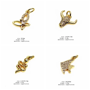 Macro detail of four gold zircon charms: butterfly, bull head, snake, and fish tail styles