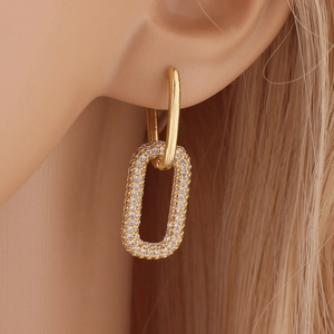 Minimalist gold U-shaped earrings with micro-paved crystals shown on a model