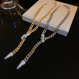 Exaggerated iced-out snake chain necklace in gold and silver finish with crystal pavé
