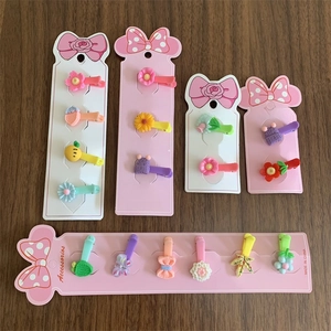 Set of colorful children hair clips with cute flower and butterfly shapes on card