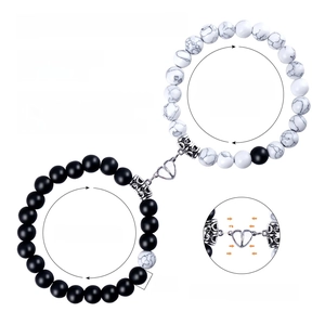Detail of 8mm natural stone couple bracelets with a heart-shaped magnetic clasp