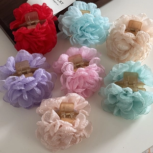 Detail of colorful tulle rose hair claws in red, blue, pink and purple shades