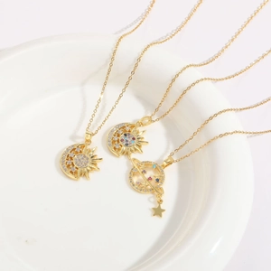 Detailed view of three 14K gold plated necklaces with sun, moon, and planet charms