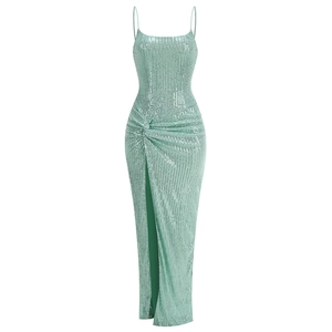 Detail of mint green sequin maxi dress featuring a high slit and cross strap waist design