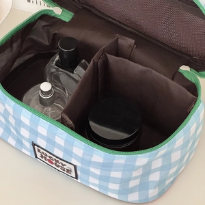 Blue and white checkered travel cosmetic bag with green zipper and spacious compartments