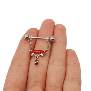 Detail of vampire lips nipple ring with red enamel, white fangs and a teardrop gemstone