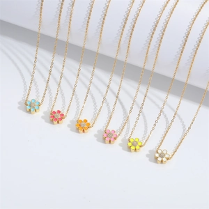 Minimalist gold flower necklaces with colorful enamel petals and sparkling crystal centers