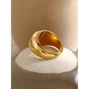 Detailed view of thick 18k gold plated chunky spiral ring on textured ceramic stone