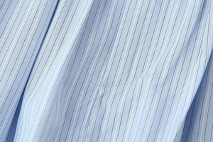 Close-up detail of blue and white striped cotton fabric texture and weave patterns