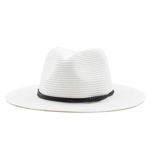 Detail of white straw Panama hat featuring fine weave and pleated black decorative band