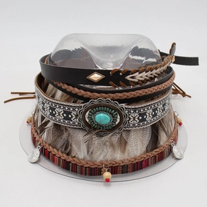 Detail of bohemian hat bands featuring turquoise stones, feathers and ethnic beadwork