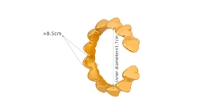 Detail view of heart-shaped gold-plated steel ring with 0.5cm width and 1.7cm diameter