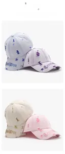 Close-up of distressed denim baseball caps with 3D letter embroidery and vintage holes