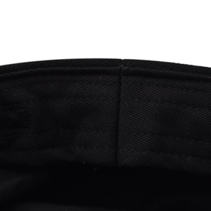 Macro shot of black twill wool fabric with detailed stitching on the beret hat band
