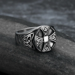 Macro shot of Viking Celtic cross and knot patterns on a silver steel ring for men
