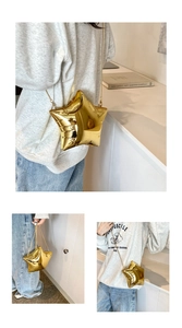 Macro detail of star-shaped crossbody bag with gold metallic finish and chain strap