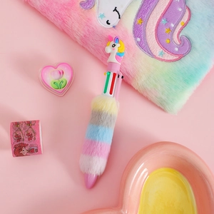 Close-up of multi-color unicorn plush pen with rainbow faux fur and matching stationery
