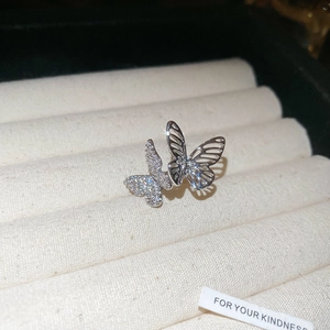 Macro shot of silver zircon butterfly ear cuff with hollow design and sparkling crystals