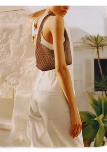 Detail of the brown leather Intrecciato woven texture on a stylish hobo shoulder bag