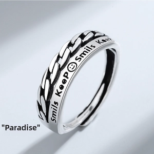 Detailed shot of adjustable silver ring with chain texture and Smils Keep engraving