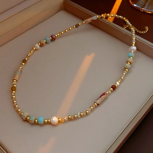 Detail of baroque pearl necklace with colorful beads in a premium jewelry box