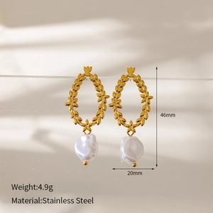 Detailed view of golden leaf earrings with white irregular pearls and dimensions info
