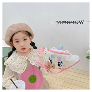 Detail of unicorn sequin waist bag with rainbow horn and pink strap held by a young girl