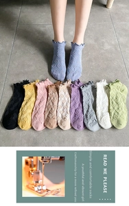 Detail of ruffle cuff socks featuring textured heart patterns in ten varied colors