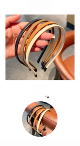 Detail of four thin leather headbands in black, coffee, caramel and cream colors