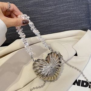 Mini heart-shaped silver metal handbag with crystal bead handle and sleek chain strap