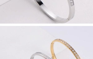 Detailed view of gold and silver bangles featuring CNC zircon inlay and size 17 engraving