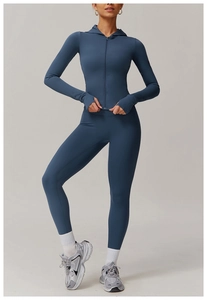Detail of blue zip-up yoga hoodie with thumbholes and matching high-waist leggings