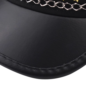 Close-up of black leather military cap featuring a silver chain and yellow star detail