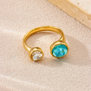 Detailed macro view of 18K gold plated stainless steel ring with blue and clear gemstones